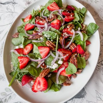 strawberry spinach salad on a plate