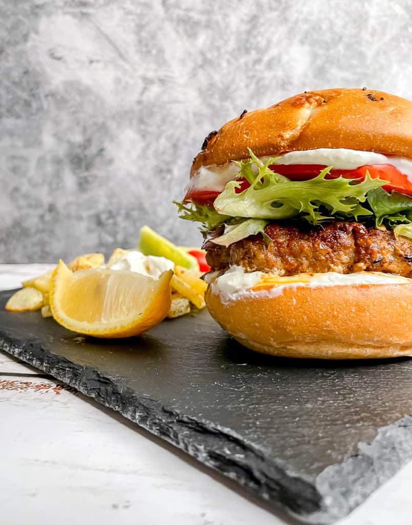 Moroccan Lamb Burger sitting on a black slate plate