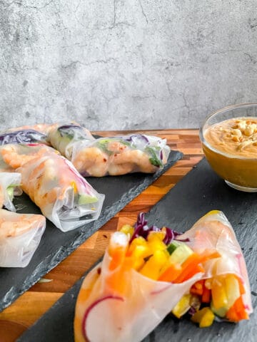 shrimp spring rolls with peanut sauce is the back ground