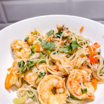bowl of shrimp and vermicelli with sautéed vegetables