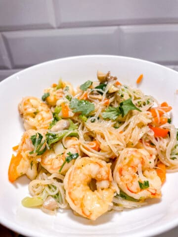 bowl of shrimp and vermicelli with sautéed vegetables