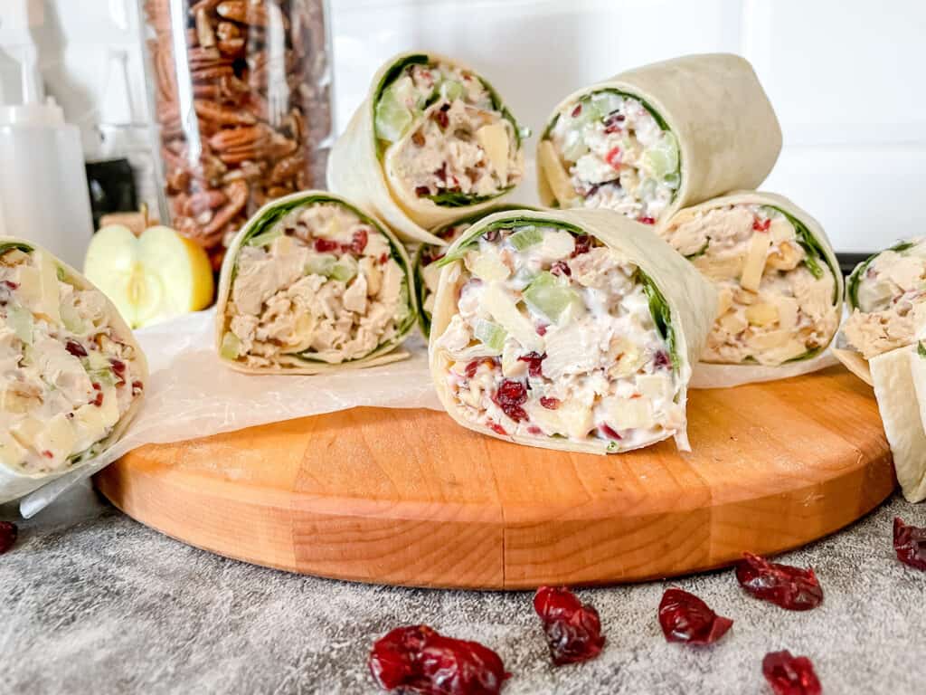 Cranberry Apple Pecan Chicken Wraps on a wooden cutting board 