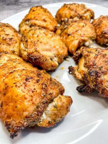 Crispy Oven Baked Chicken Thighs on a white platter