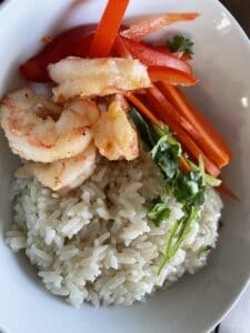 Garlic shrimp, coconut rice and julienned vegetables Served in a bowl