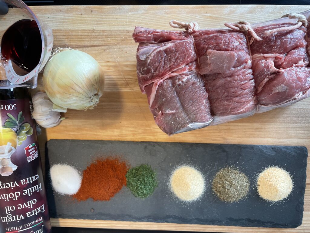 ingredients for pulled beef. Cross rib roast, onion, garlic, red wine vinegar, spices 