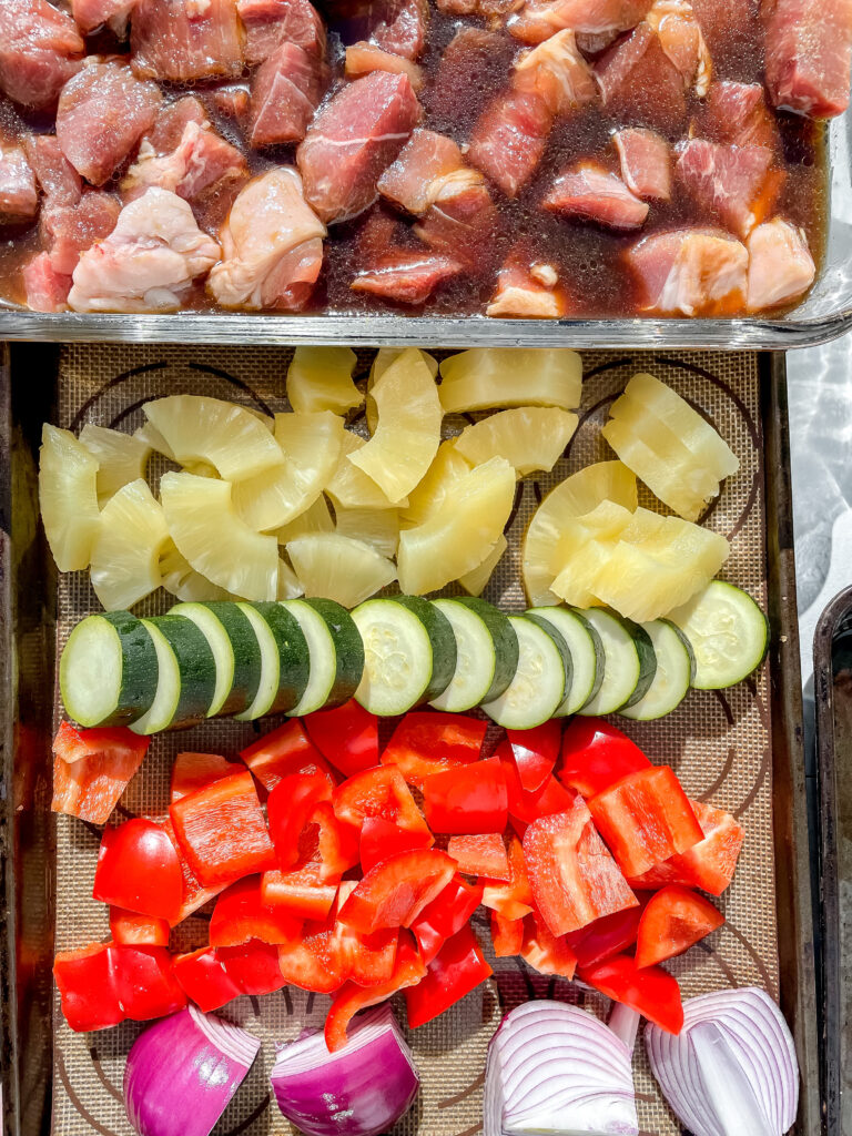 Ingredients for Trager Kabobs on a sheet pan, Pork, Pineapple, Zucchini, Red Pepper, Red Onion