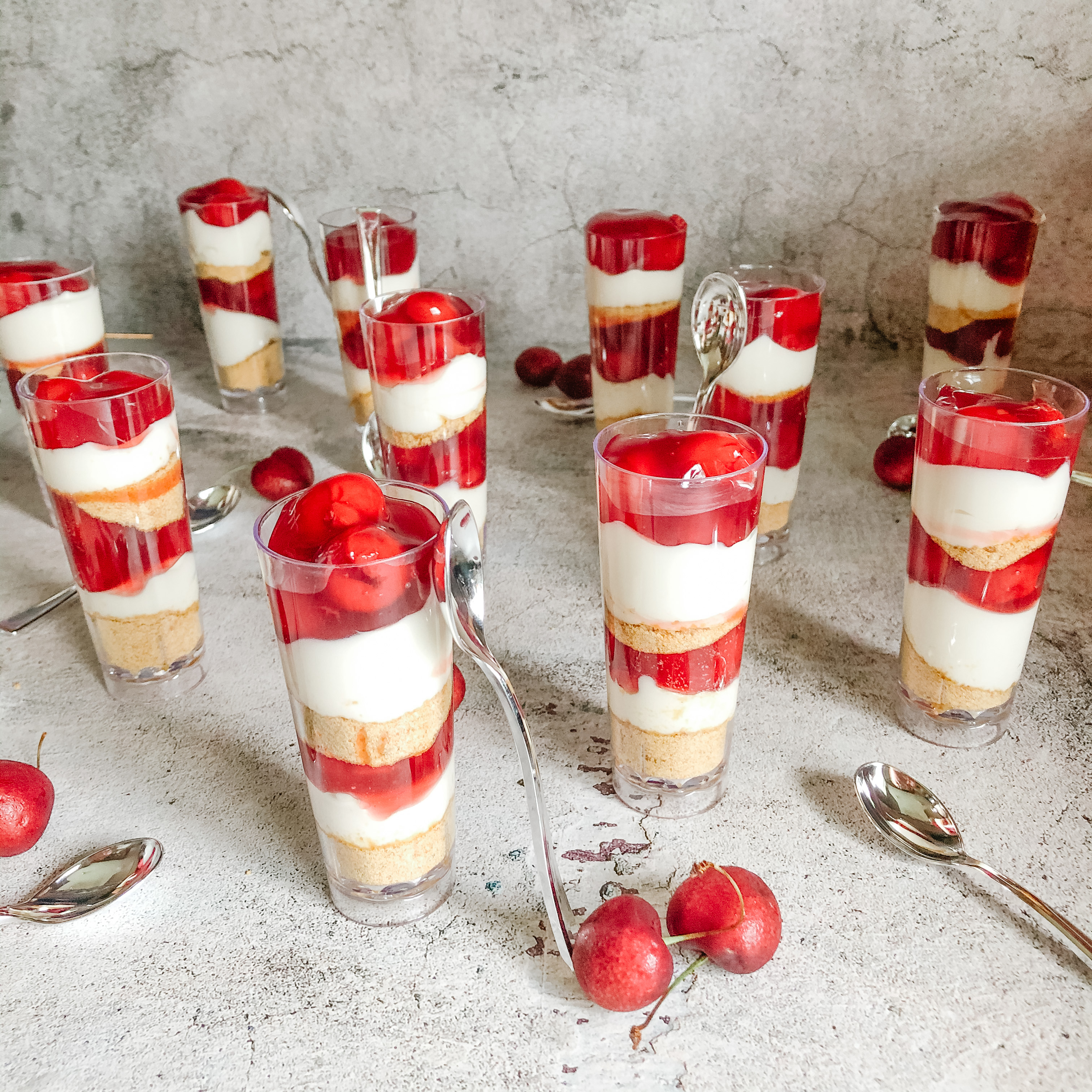 Mini Cherry Cheesecake cups with spoons in shot glasses