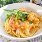 Coconut Red Curry Noodles with Garlic Shrimp in a bowl.