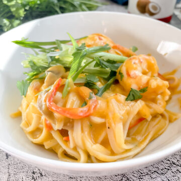 Coconut Red Curry Noodles with Garlic Shrimp in a bowl.