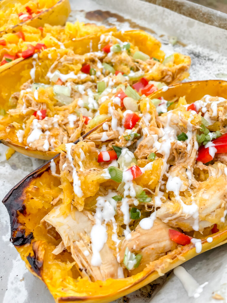 Buffalo chicken spaghetti squash topped with ranch and fresh vegetables